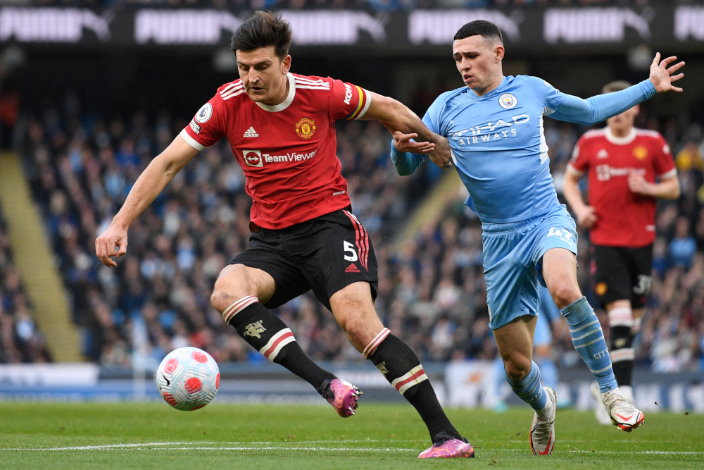 Manchester United defender Harry Maguire vies with Manchester City midfielder Phil Foden during the English Premier League match at the Etihad Stadium in Manchester, north-west England, March 6, 2022. u00e2u20acu201d AFP pic 