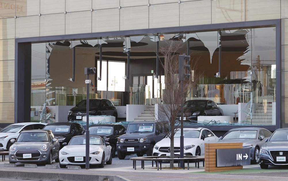 A car dealership's window is broken following a strong earthquake in Koriyama, Fukushima prefecture, Japan in this photo taken by Kyodo on March 17, 2022. u00e2u20acu2022 Kyodo/via Reuters