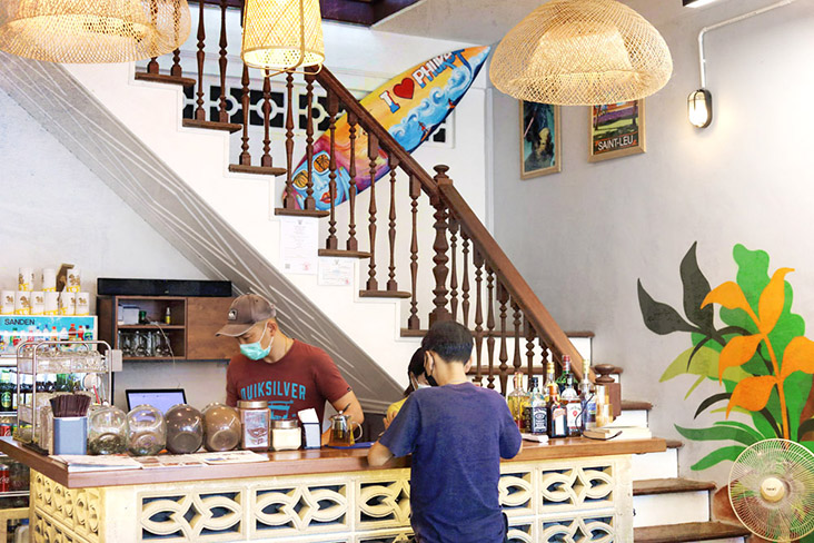 Owner Joe Ang manning the counter at Lao Pa Sat, which has a beach town feel to its décor.