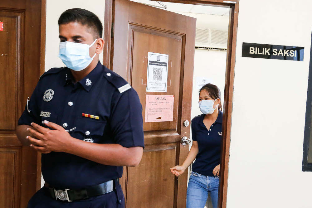 Nurse Lim Cheng Wooi enters the courtroom at George Town Sessions Court, March 29, 2022. u00e2u20acu201d Picture by Sayuti Zainudin