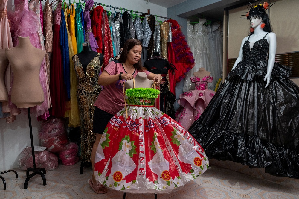 Lenora Buenviaje displays a dress made of used sacks of rice and plastic bags, at her shop in Cainta, Rizal Province, Philippines March 3, 2022. u00e2u20acu2022 Reuters pic