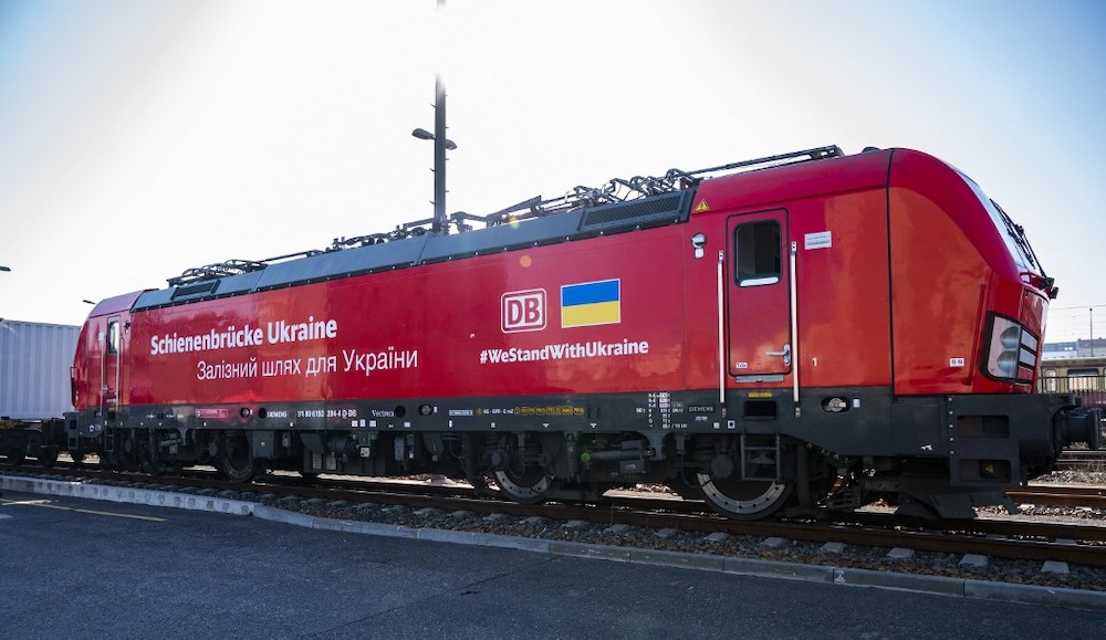 An engine bringing aid supplies to the Ukraine departs from the BEHALA container terminal in Berlin on March 24, 2022; Inscription reads: u00e2u20acu02dcRail bridge for the Ukraineu00e2u20acu2122. u00e2u20acu201d AFP pic