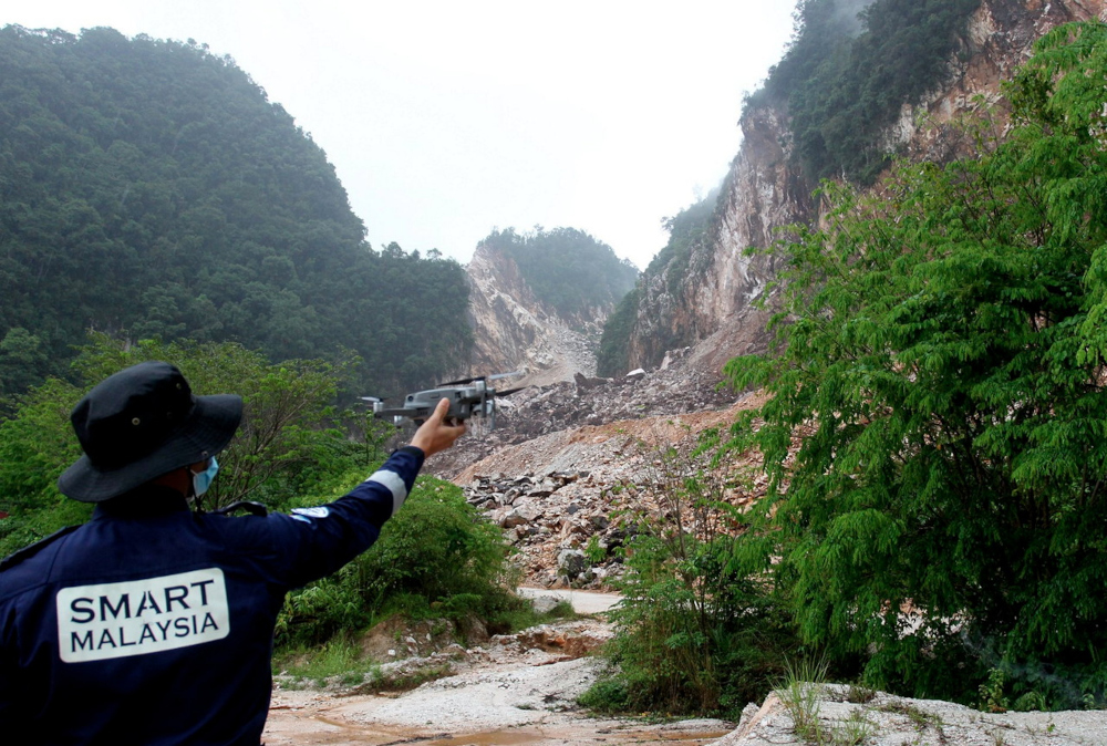 A Special Malaysia Disaster Assistance and Rescue Team member uses a drone in search and rescue efforts for two men trapped in the rubble by a quarry rockfall incident in Keramat Pulai, Jalan Simpang Pulai-Cameron Highland, March 8, 2022. u00e2u20acu201d Bernama pic 