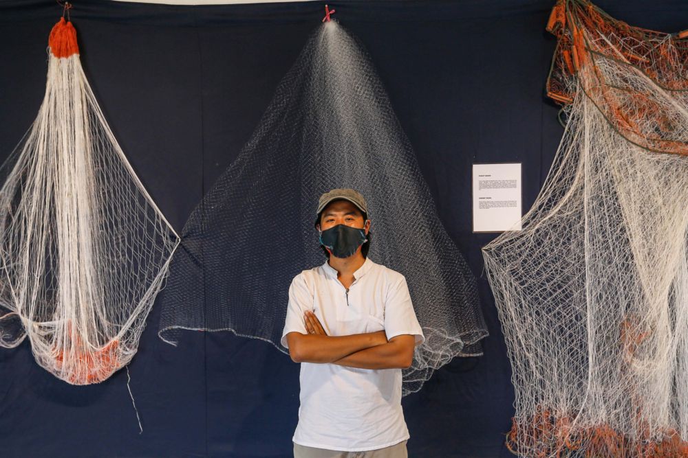 Project Coordinator for the Coastal Fishermen Exhibition Andrew Han is pictured with one of his installation in his exhibition at Hin Bus Depot in George Town, Penang, March 4, 2022. — Picture by Sayuti Zainudin