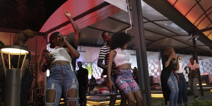 Customers dance as South African amapiano dancer and singer Kamo Mphela (unseen), Amapiano Artist of 2021, performs at a nightclub in Johannesburg.u00e2u20acu201d ETX Studio picnn