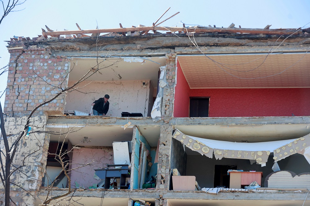 A man cleans a room in an apartment building destroyed during an air raid, amid Russia's invasion of Ukraine, in Kyiv, Ukraine March 21, 2022. u00e2u20acu2022 Reuters pic