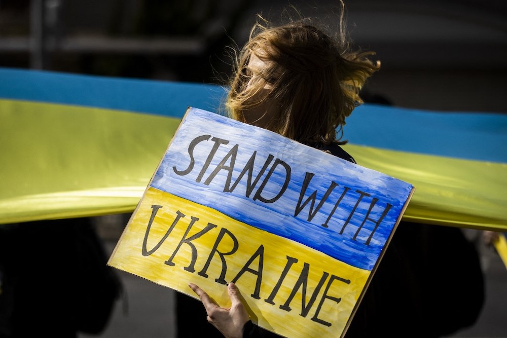 A protestor holds a placard as she takes part in a protest against Russiau00e2u20acu2122s actions in Ukraine, during a rally in Tokyo on March 5, 2022. u00e2u20acu2022 AFP picnn
