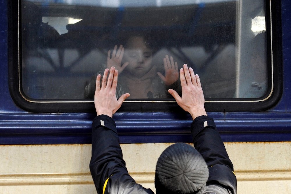 A man gestures in front of an evacuation train at Kyiv central train station on March 4, 2022. u00e2u20acu2022 AFP picnn