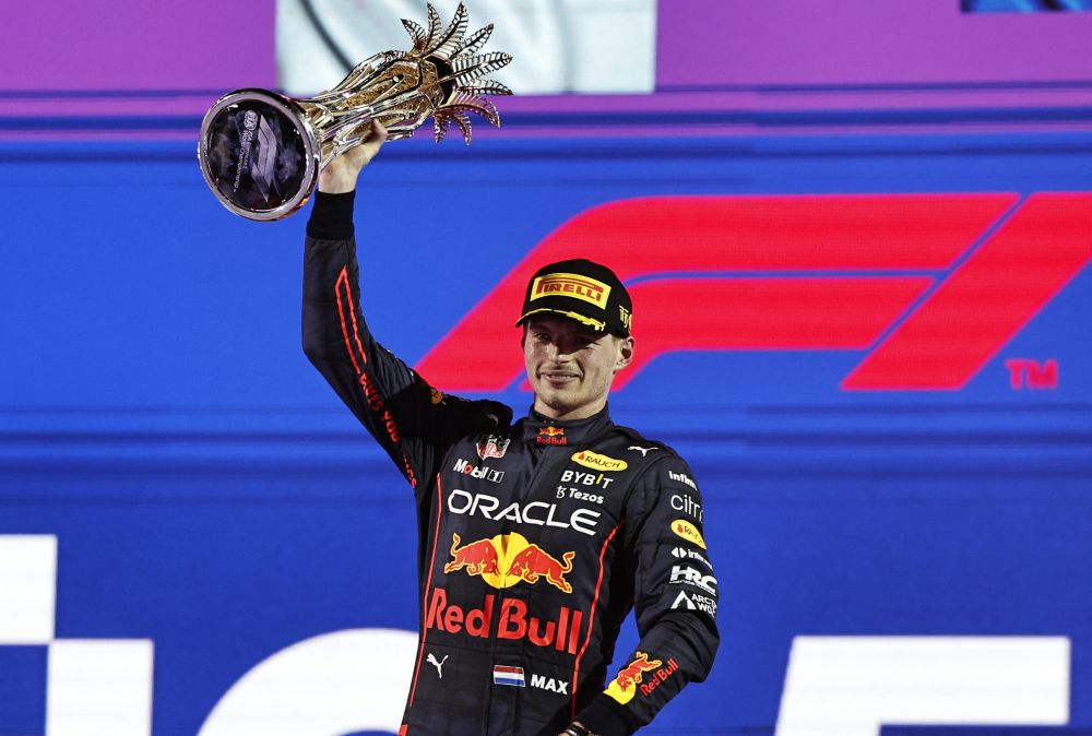nRed Bull's Max Verstappen celebrates on the podium with the trophy after winning the Saudi Arabia Grand Prix at the Jeddah Corniche Circuit, Jeddah March 27, 2022. u00e2u20acu201d Reuters picn