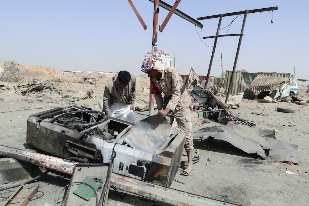 A man and a soldier inspect damage at a gas station hit by a Saudi-led air strike in Saada, Yemen March 26, 2022. u00e2u20acu201d Reutersnn