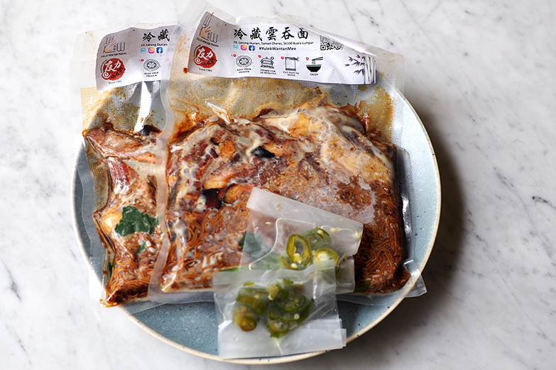 The frozen noodles are packed with instructions on how to steam them. You also get pickled green chillies with it.