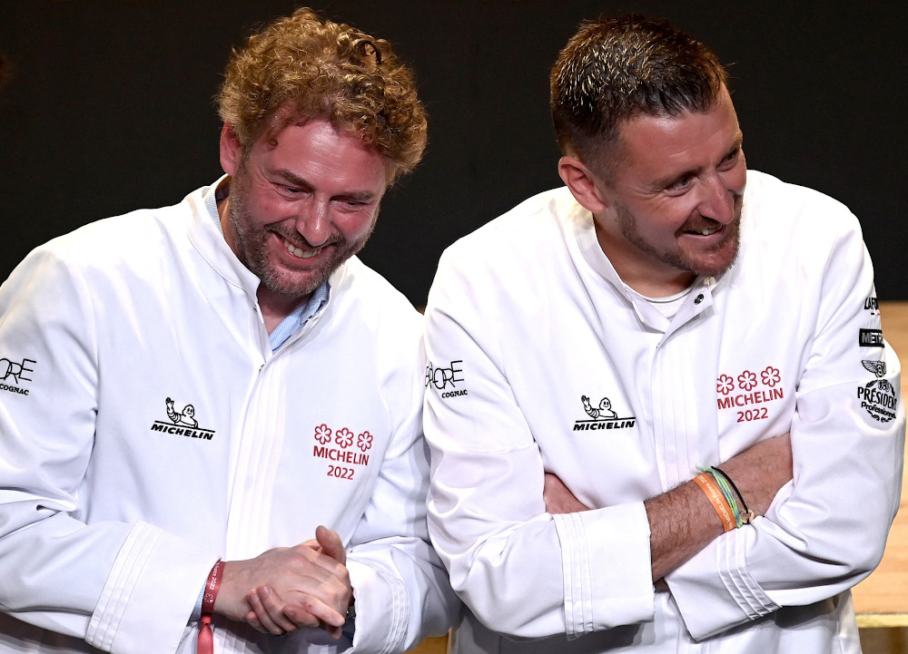 (From left) French chef Arnaud Donckele and French chef Dimitri Droisneau celebrate after being awarded a third Michelin star during the 2022 edition of the Michelin guide award ceremony. u00e2u20acu201d AFP pic 
