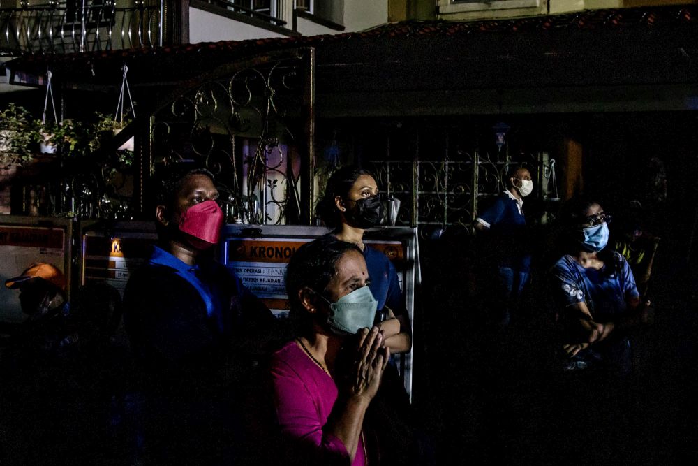 Residents look on as search and rescue operations are carried out at the site of a landslide at Taman Bukit Permai 2 Ampang March 11, 2022. u00e2u20acu201d Picture by Firdaus Latifnn