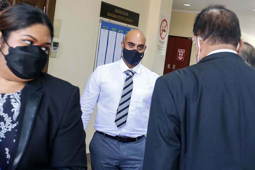 Gregory Steven Jenkins (centre), son of the late Annapuranee Jenkins, is pictured at the George Town Sessions Court March 31, 2022. — Picture Sayuti Zainudin