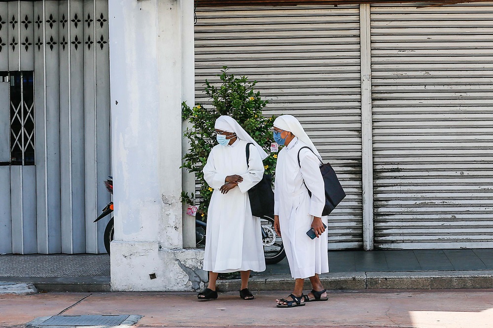Little Sisters of the Poor Home for the Aged Caragiver Sister Anges Cecillia T. Arulandu (left) is pictured leaving the George Town Sessions Court March 31, 2022. — Picture Sayuti Zainudin