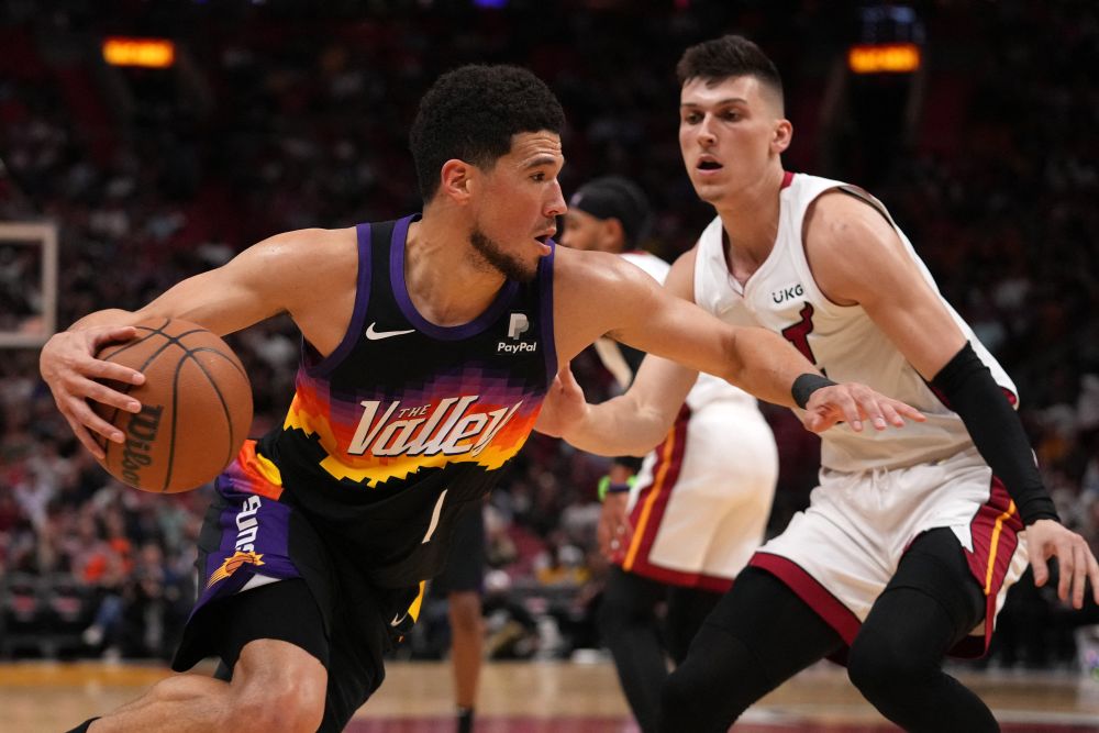 Phoenix Suns guard Devin Booker (1) drives the ball around Miami Heat guard Tyler Herro (14) during the first half at FTX Arena in Miami March 9, 2022. u00e2u20acu201d Reuters pic