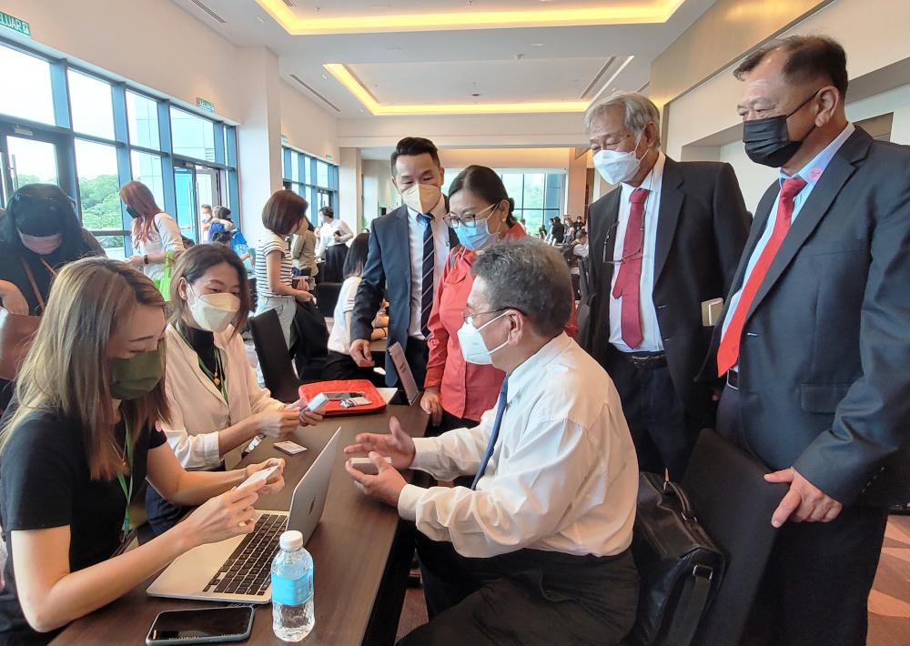Paul Paw (seated), together with (from right), Lawrence Wong, Jimmy Wong, Noredah Othman and Vincent Sia listening to what the tourism players who take part in the Sabah Tourism B2B Event has to offer. u00e2u20acu201d Borneo Post pic