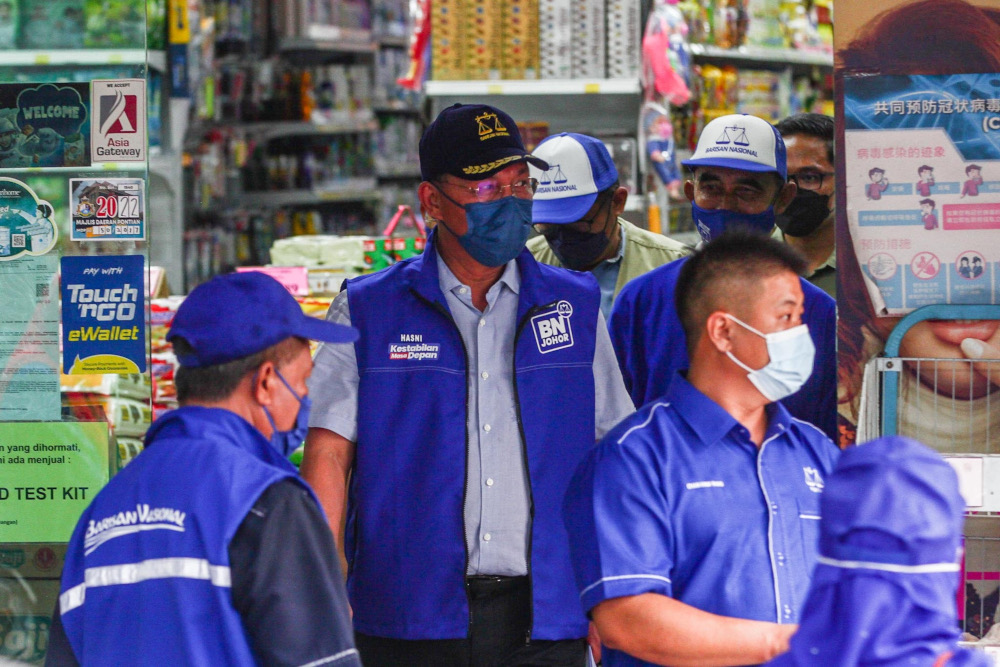 Candidate N53 Benut, Datuk Hasni Mohammad during a walkabout session in conjunction with the 15th Johor state election in Kampung Parit Bertak, Benut, March 8, 2022. — Picture by Hari Anggara