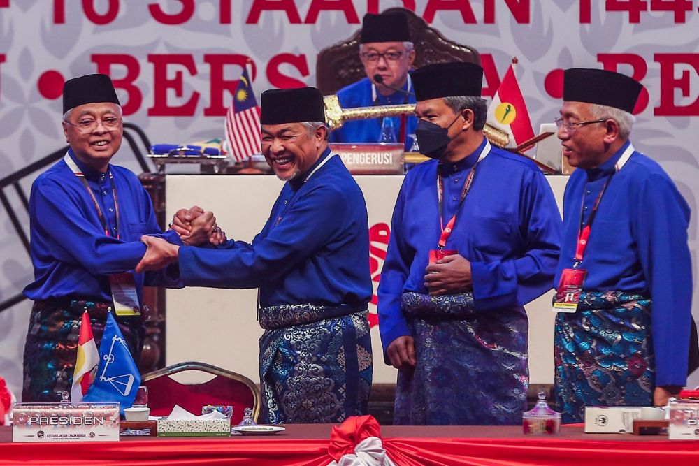 Datuk Seri Ismail Sabri Yaakob is greeted by Umno president Datuk Seri Ahmad Zahid Hamidi after the formeru00e2u20acu2122s speech at the 2021 Umno General Assembly at the World Trade Centre Kuala Lumpur March 19, 2022. u00e2u20acu201d Picture by Hari Anggara