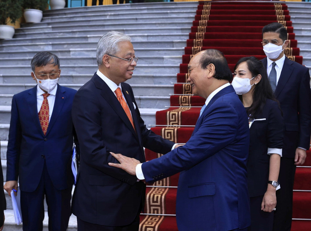 Prime Minister Datuk Seri Ismail Sabri Yaakob greets Vietnam President Nguyen Xuan Phuc at the Presidential Palace in Hanoi, March 21, 2022. u00e2u20acu201d Bernama pic 