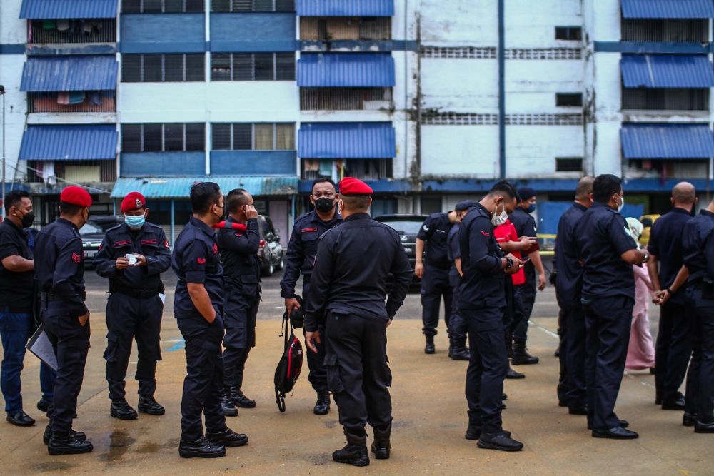 Police personnel wait to cast their votes during early voting for the Johor state election in Johor Baru March 8, 2022. — Picture by Hari Anggara