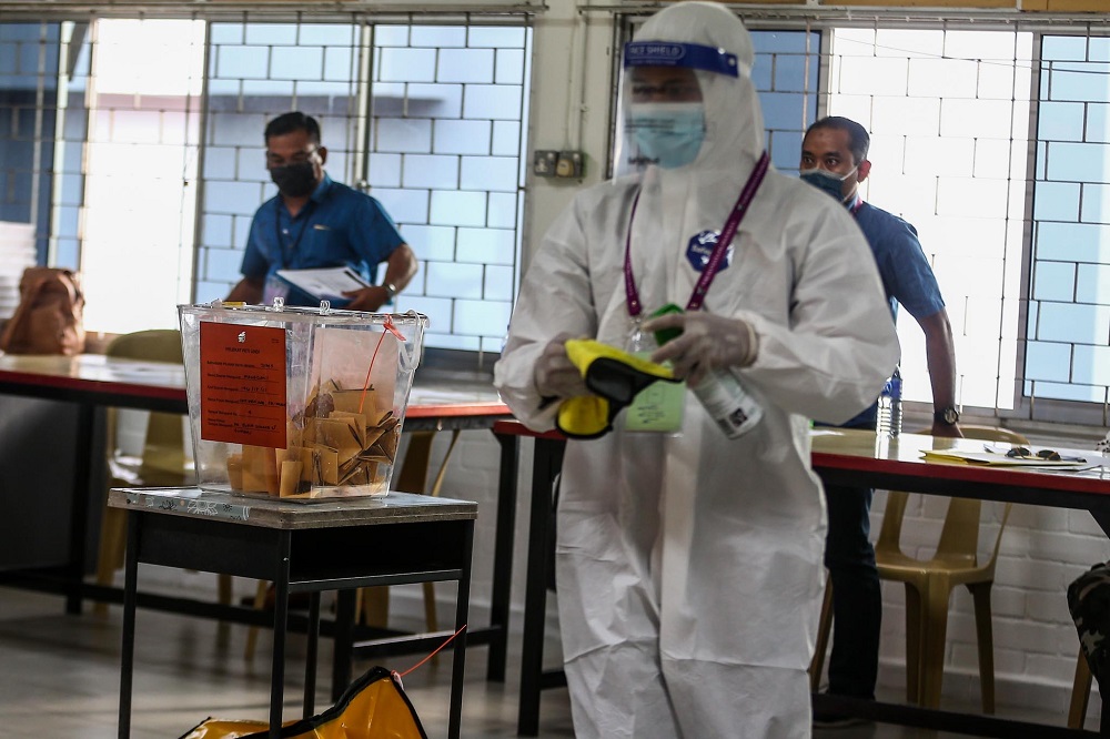 A health worker carries out sanitation work at the SMK Sri Muar polling station in Muar, Johor March 12, 2022. u00e2u20acu2022 Picture by Hari Anggara