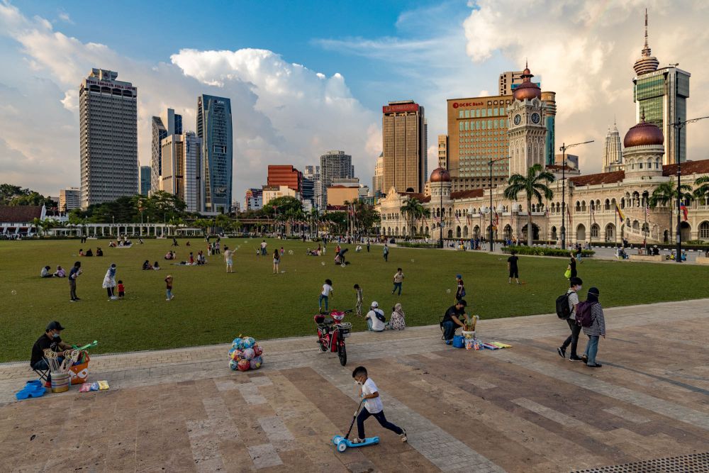 People wearing face masks enjoy an evening out Dataran Merdeka, Kuala Lumpur March 27, 2022. u00e2u20acu201d Picture by Firdaus  Latif
