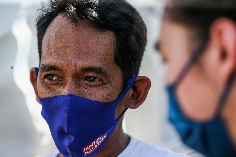 Rashidi Sukiman, 48, speaks during an interview with Malay Mail at the Felda Air Hitam district voting centre March 03, 2022. — Picture by Hari Anggara