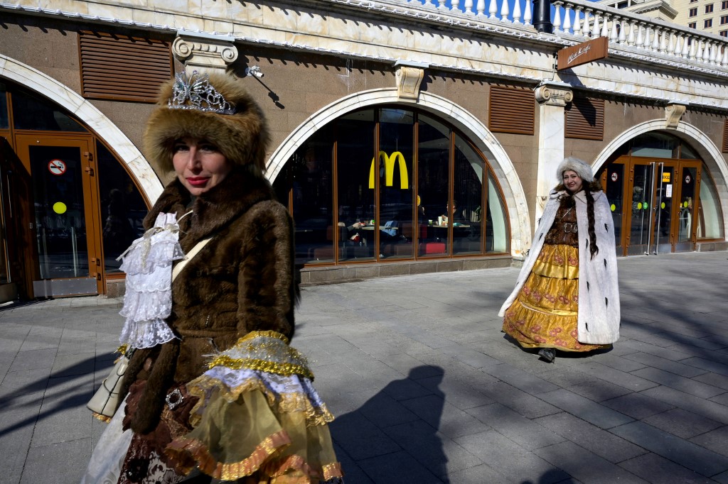 Women walk in front of a McDonald's restaurant in central Moscow on March 9, 2022. McDonald's, Coca-Cola and Starbucks on March 8, 2022 bowed to public pressure and suspended their operations in Russia. u00e2u20acu201d AFP pic