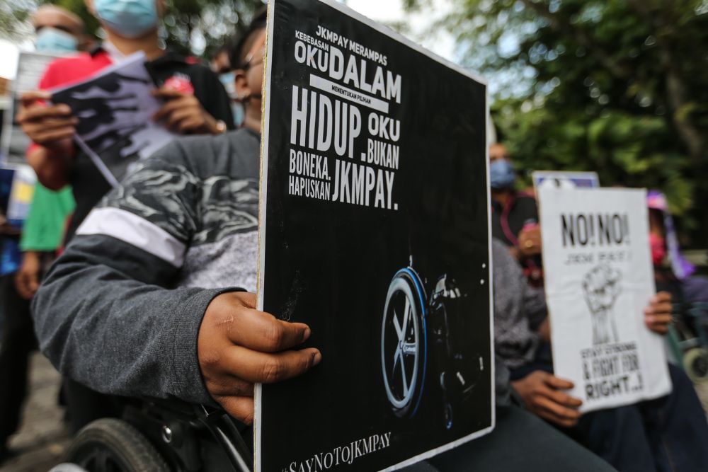 Members of the disabled community protest the Social Welfare Departmentu00e2u20acu2122s cash payment system outside Parliament in Kuala Lumpur March 1, 2022. u00e2u20acu2022 Picture by Ahmad Zamzahuri