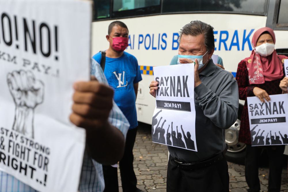 Members of the disabled community protest the Social Welfare Departmentu00e2u20acu2122s cash payment system outside Parliament in Kuala Lumpur March 1, 2022. u00e2u20acu2022 Picture by Ahmad Zamzahuri