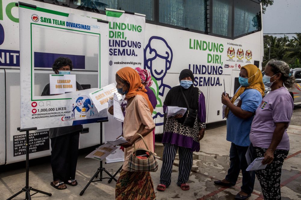 Members of the Mah Meri tribe get their first Covid-19 jab in Pulau Carey. — Picture by Firdaus Latif 