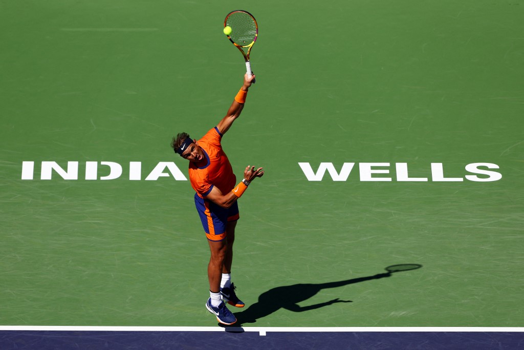 Rafael Nadal of Spain serves against Sebastian Korda of the United States in their second round match on Day 6 of the BNP Paribas Open at the Indian Wells Tennis Garden on March 12, 2022 in Indian Wells, California. u00e2u20acu201d Getty Images via AFP