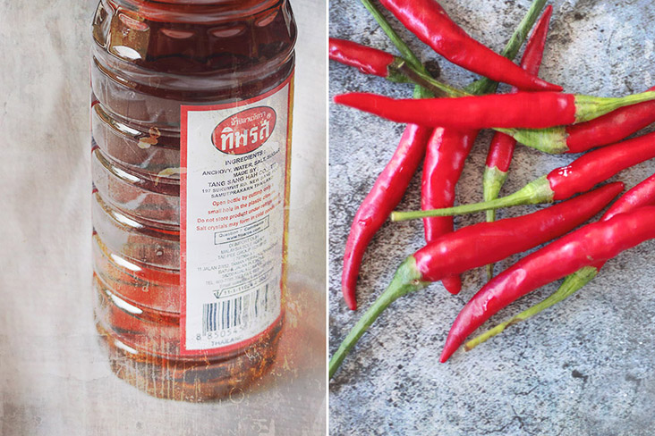 Pungent and briny 'nam pla' or Thai fish sauce (left). Fiery 'cili padi' or bird’s eye chillies (right).