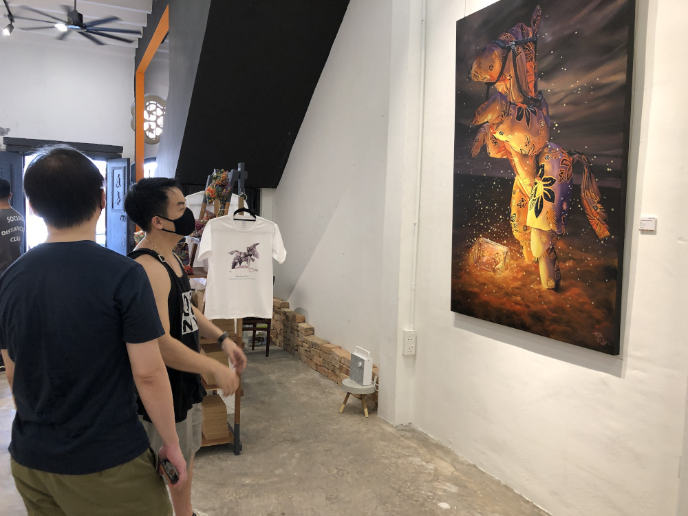 Visitors at the Orikata Tales exhibition. — Picture by Opalyn Mok