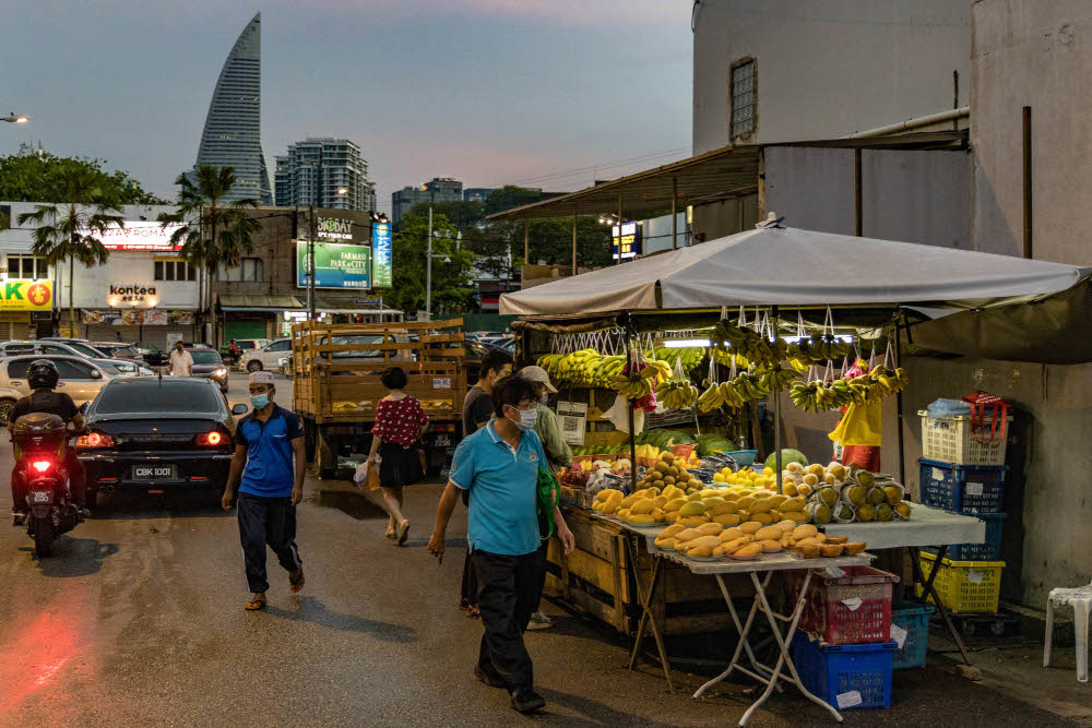 People wearing face masks walk on the street in Bangsar, March 29, 2022. u00e2u20acu201d Picture by Firdaus Latif 