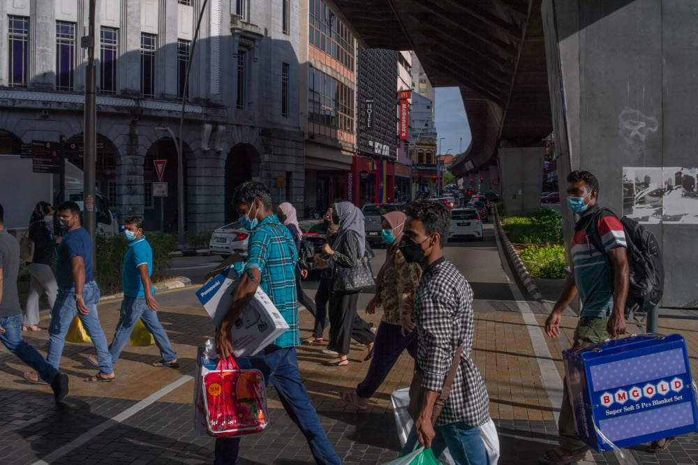 People are seen wearing protective masks as they walk along the Jalan Tun Perak in Kuala Lumpur, March 3, 2022. u00e2u20acu201d Picture by Shafwan Zaidon