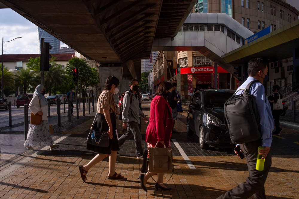 People are seen wearing protective masks as they walk along the Jalan Tun Perak in Kuala Lumpur, March 3, 2022. u00e2u20acu201d Picture by Shafwan Zaidon
