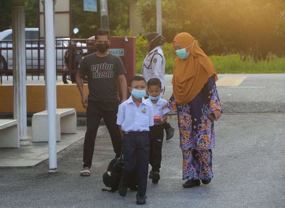 Primary school students return to school at Sekolah Kebangsaan Syed Idrus Chemor in Perak March 21, 2022. u00e2u20acu201d Picture by Farhan Najibnn