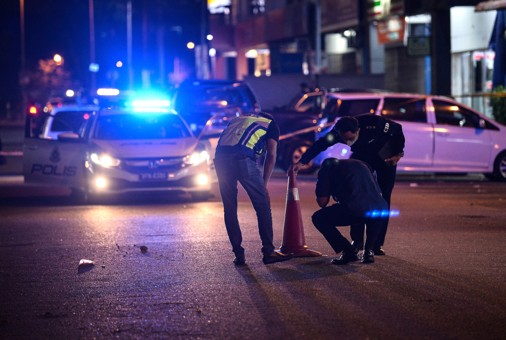 Police officers conduct an investigation in front of a bank compound in a robbery incident in Puchong Prima, March 11, 2022. u00e2u20acu201d Bernama pic 