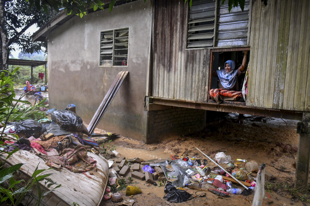 A resident looks at the wall of her home which collapsed during the floods in Kampung Bukit Gemuruh in Hulu Terengganu, March 4, 2022. u00e2u20acu2022 Bernama pic 