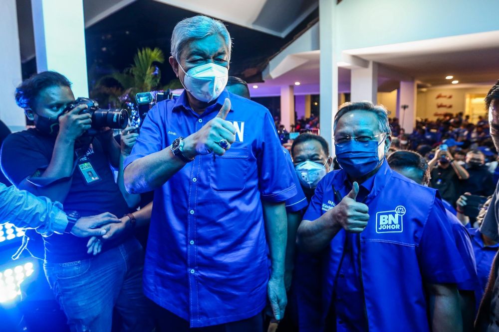 Barisan Nasional chairman Datuk Seri Ahmad Zahid Hamidi (left) and Datuk Hasni Mohammad arrive at the Johor Umno Liaison Hall in Johor Baru March 12, 2022. u00e2u20acu201d Picture by Hari Anggarann
