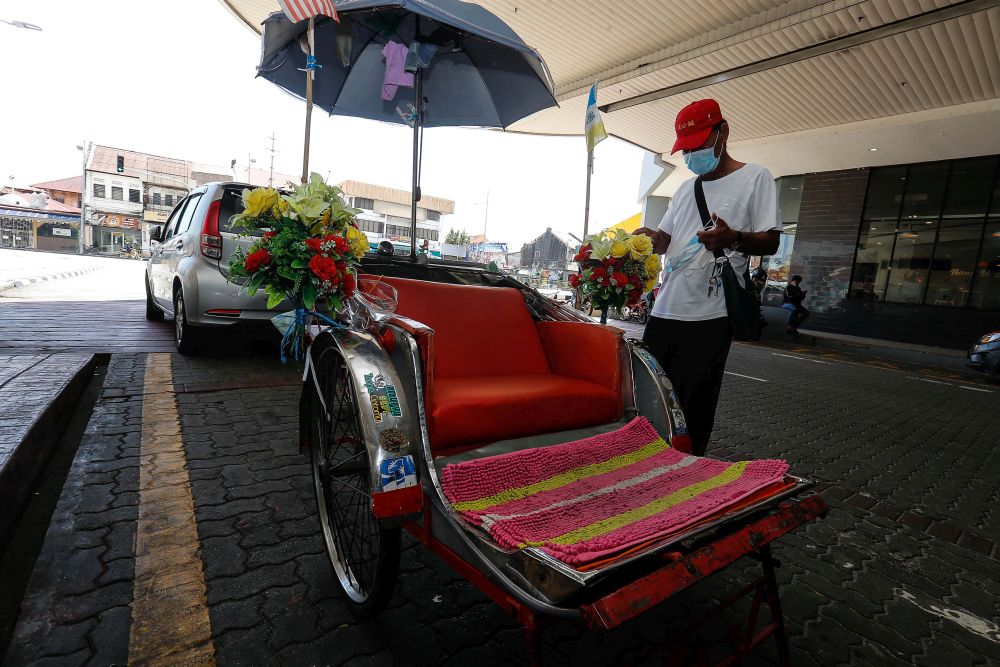 Noordin Lazim is pictured with his trishaw at Komtar, George Town March 16, 2022. — Picture by Sayuti Zainudin