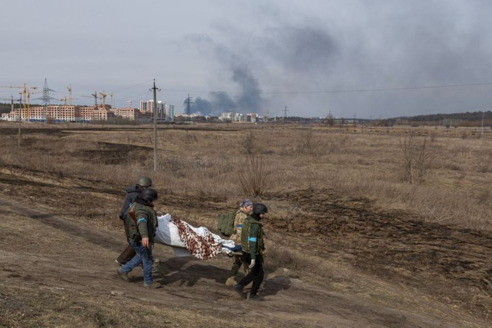 Ukrainian servicemen carry a dead body on stretcher as Russiau00e2u20acu2122s invasion of Ukraine continues, in the town of Irpin outside Kyiv, Ukraine, March 12, 2022. u00e2u20acu201d Reuters pic