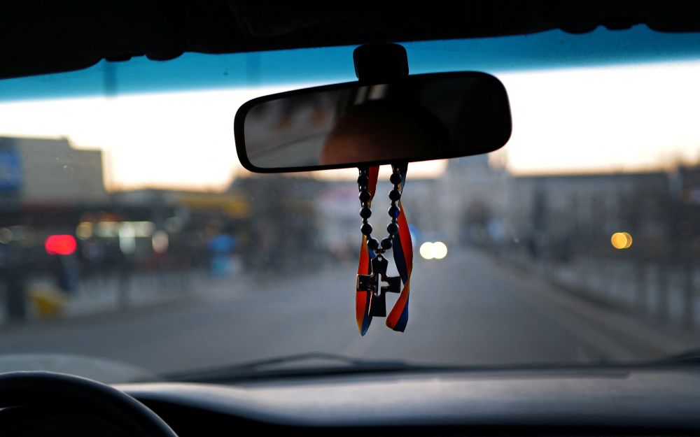 A cross and a ribbon in the colours of the Ukrainian flag as a lucky charm are seen inside a taxi during the ongoing Russian invasion in Lviv, Ukraine March 14, 2022. u00e2u20acu201d Reuters pic