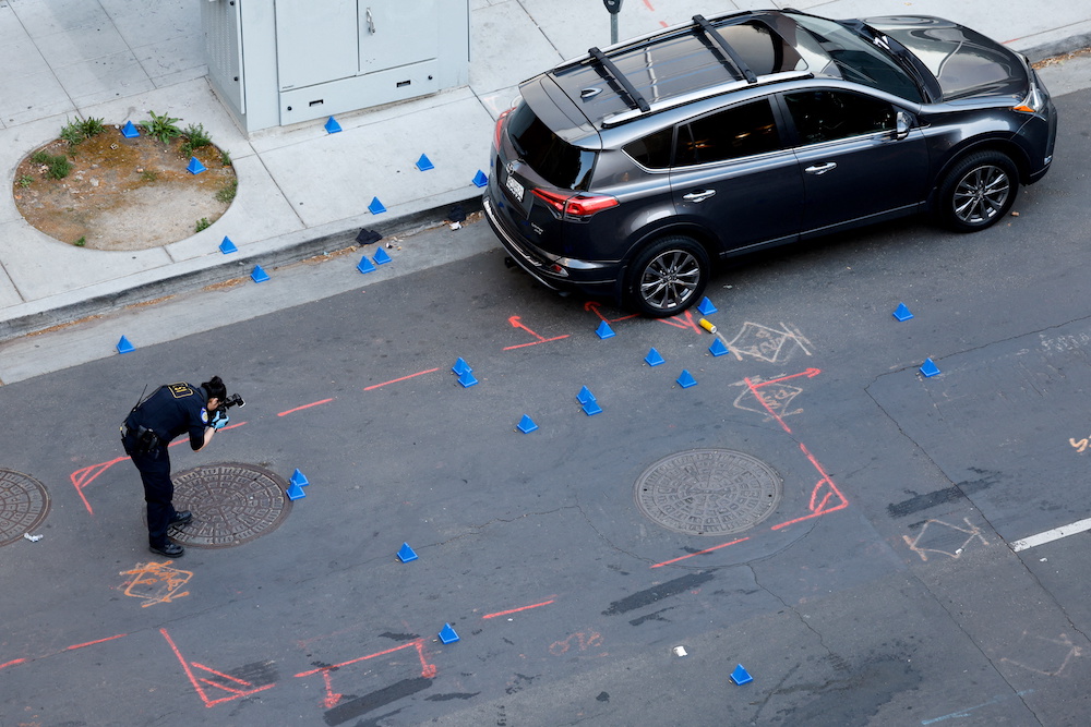 A police evidence technician photographs the crime scene after an early-morning shooting in a stretch of downtown near the Golden 1 Center arena in Sacramento, California April 3, 2022. u00e2u20acu201d Reuters pic