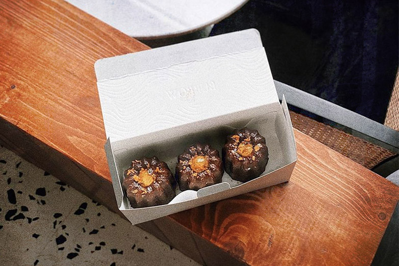 A box of Burrow’s Lucky Marmalade 'canelés' to bring home or give to a loved one.