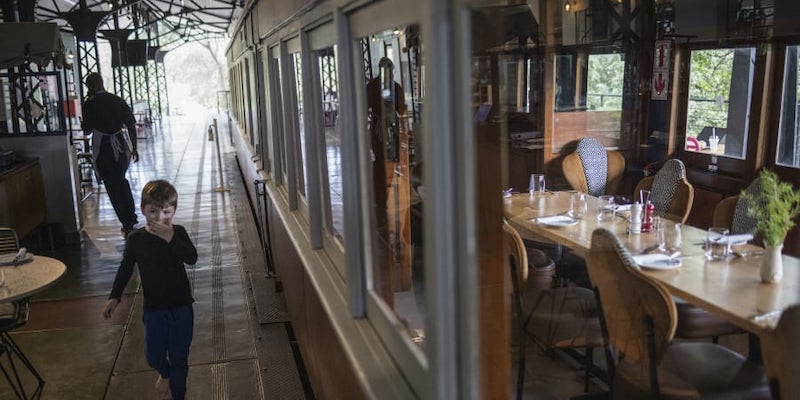 A kid walks past a converted train carriage at the Kruger Station in Skukuza, Kruger National Park. u00e2u20acu201d AFP pic