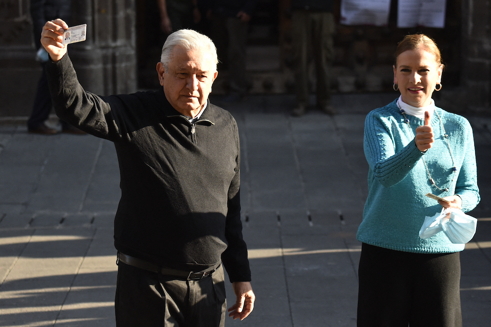 Mexican President Andres Manuel Lopez Obrador and his wife Beatriz Gutierrez show their voter ID after voting at a polling station during the national consultation on the revocation of his mandate in Mexico City April 10, 2022. u00e2u20acu201d AFP pic