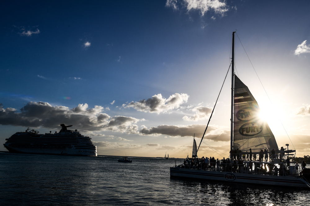 Tourists ride on a boat as the Carnival Dream cruise ship sails in Key West, Florida on April 11, 2022. u00e2u20acu201d AFP pic